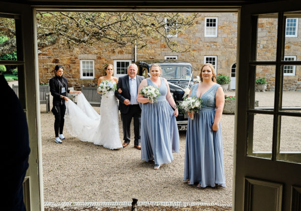 Bride and bridesmaids entering the Garden room at La Mare Wine Estate, Jersey