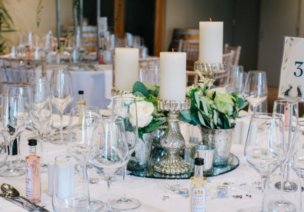 Table setting with candles and glasses for wedding reception at vineyards in Jersey, La Mare Wine Estate