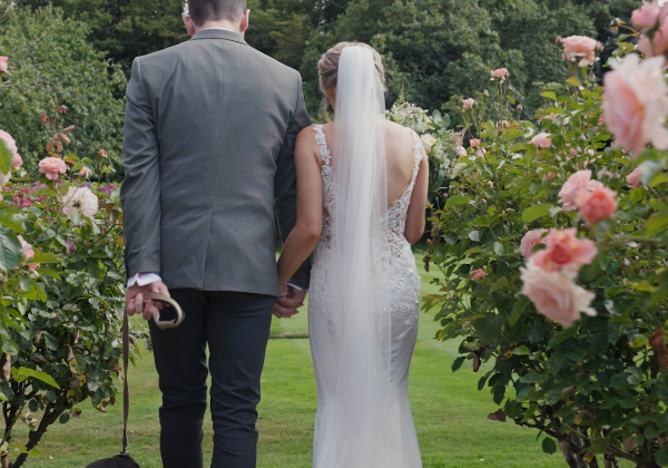 Bride and groom in rose garden at La Mare Wine Estate, Jersey