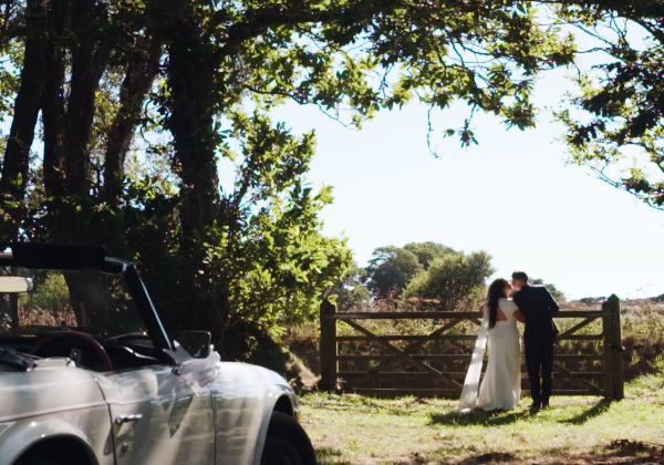 Bride and groom in the vineyard with classic car at La Mare Wine Estate