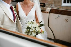 bride in car holding wedding bouquet at la mare wine estate