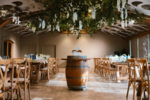 Wine barrel amongst tables in The Winery at La Mare Wine Estate